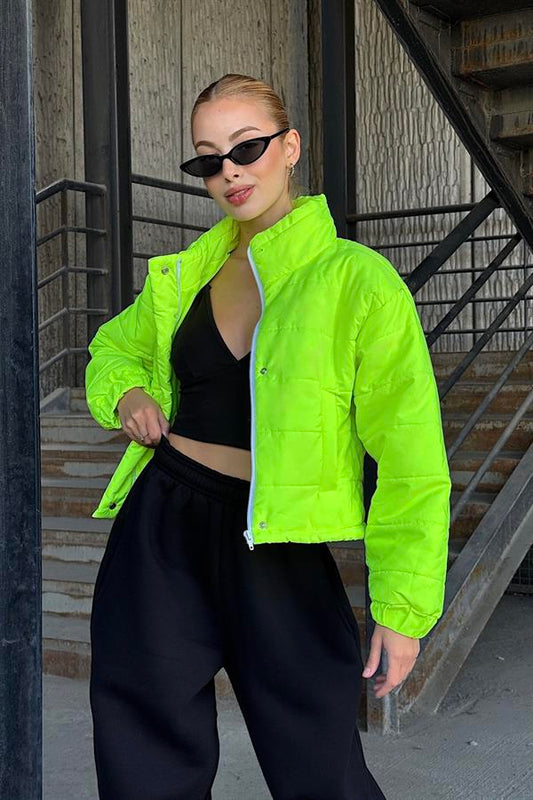 Neon yeşil renkli, dik yakalı, çıtçıtlı ve fermuarlı kısa şişme mont.