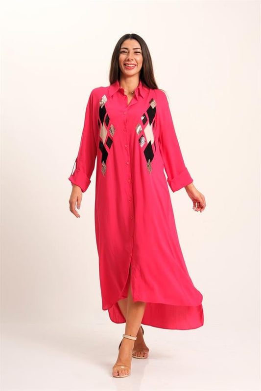A woman wears a long-sleeved pink shirt dress featuring sequined diamond patterns on the chest.