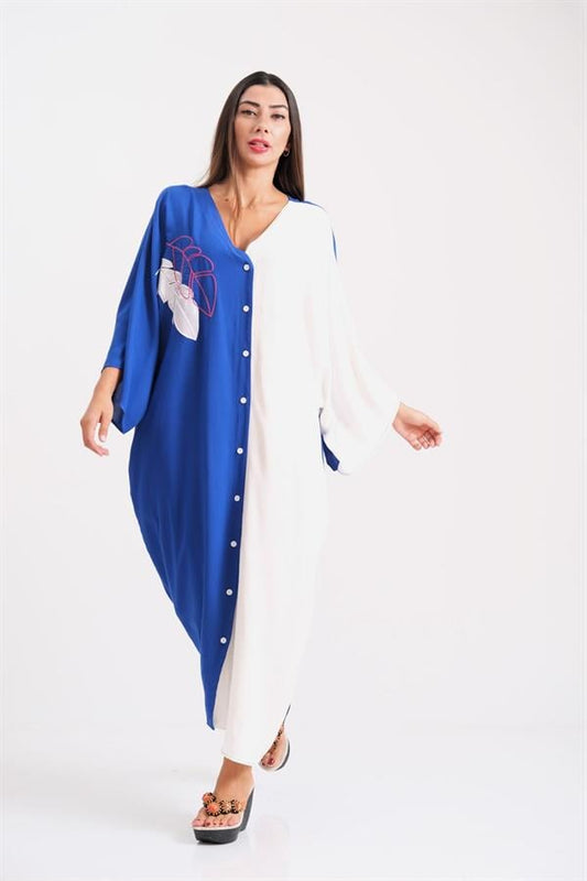 A model wears a two-tone blue and white oversized button-down shirt dress with leaf embroidery.