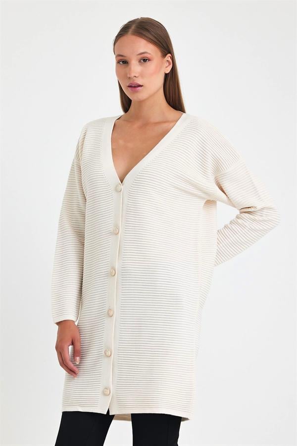 Beyaz renkli, fitilli dokuya sahip, düğmeli ve uzun triko hırka.