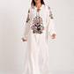 A white long dress with authentic embroidery on the front and sleeves, featuring tassel ties.