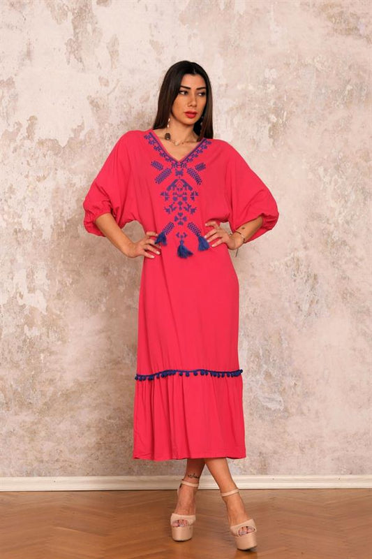 Fuşya rengi, V yaka, önü nakışlı ve püsküllü, etek ucu fırfırlı ve ponponlu uzun viskon elbise.