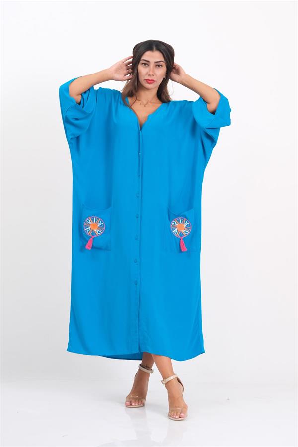 Mavi renkli, V yakalı, önü düğmeli, cepleri nakışlı ve püsküllü oversize uzun elbise.