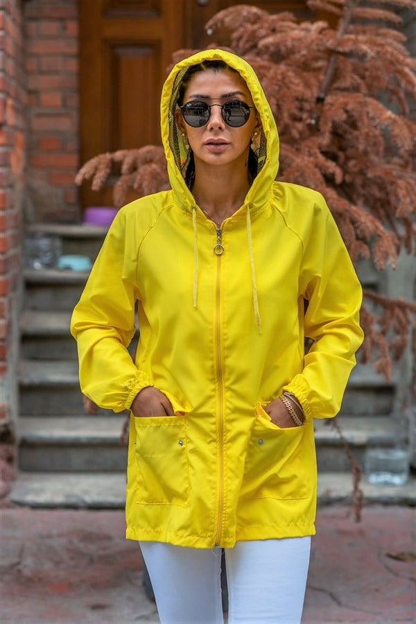 Fermuarlı, kapüşonlu ve cepli sarı renkli ince kadın yağmurluk.